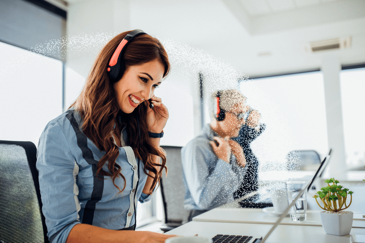Smiling woman wearing headset looking at computer