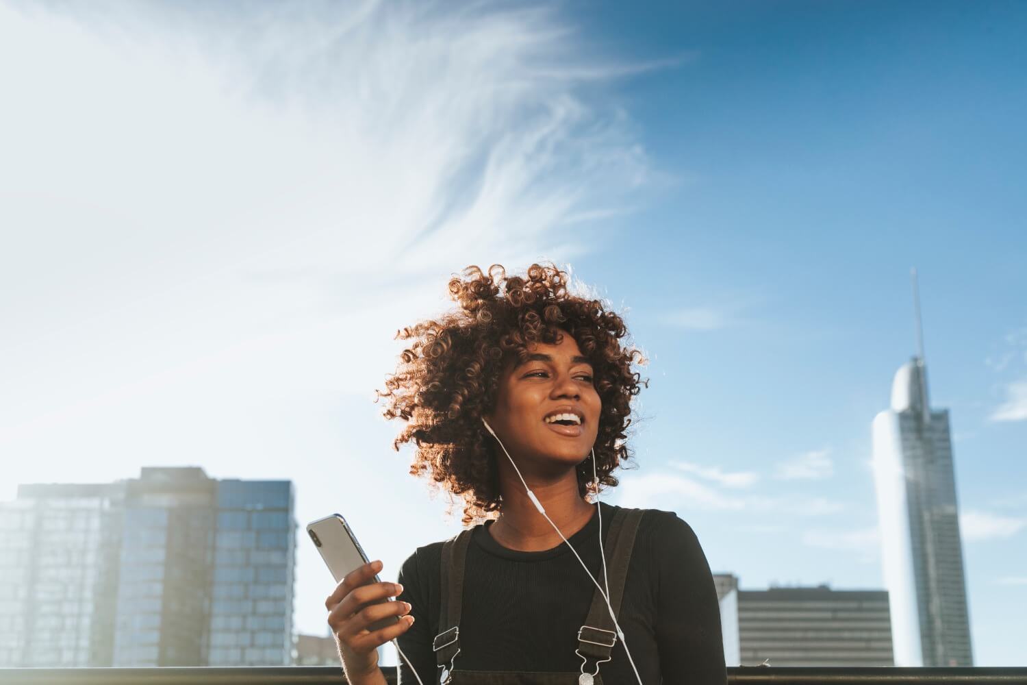 Woman smiling holding phone