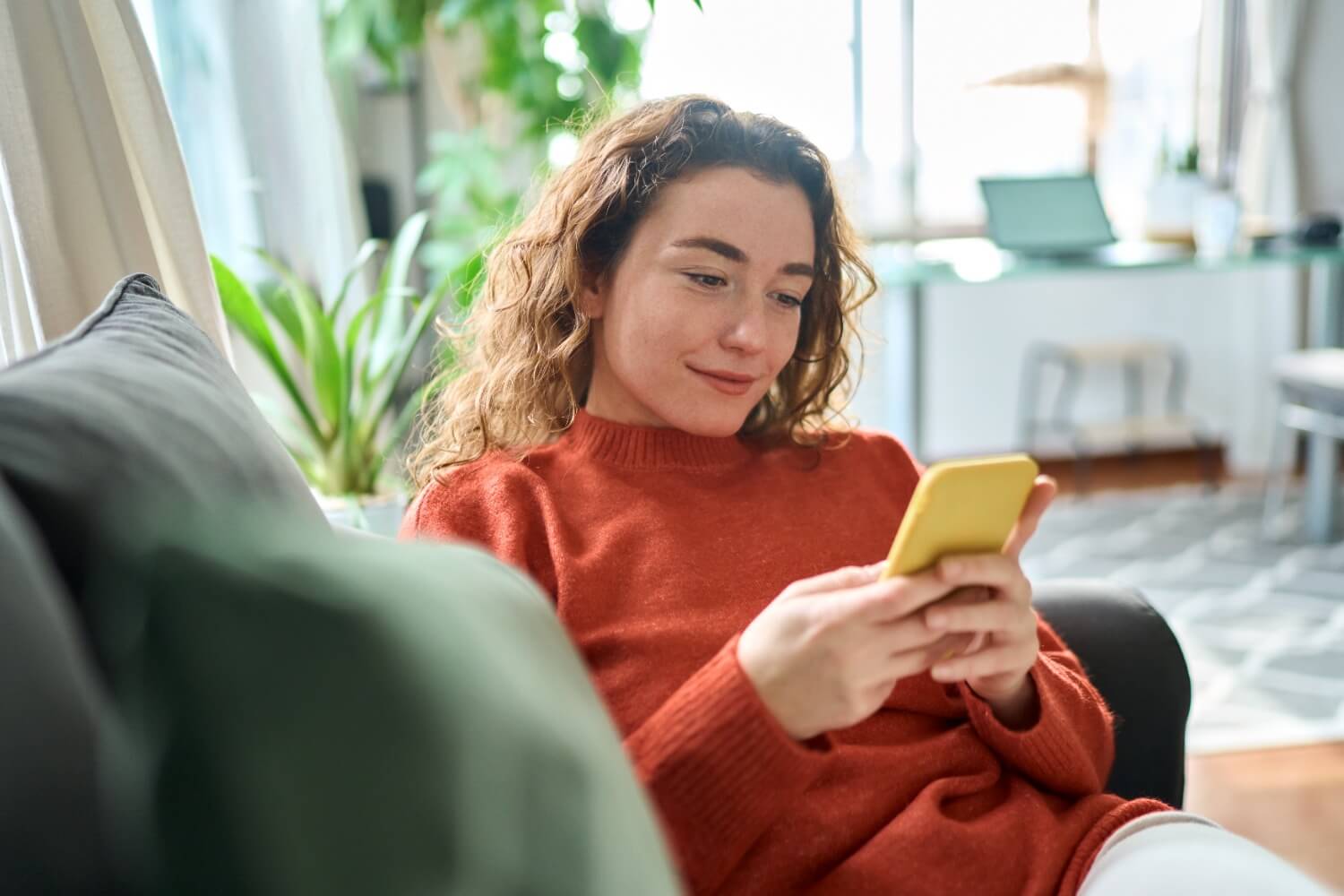 Smiling woman using phone