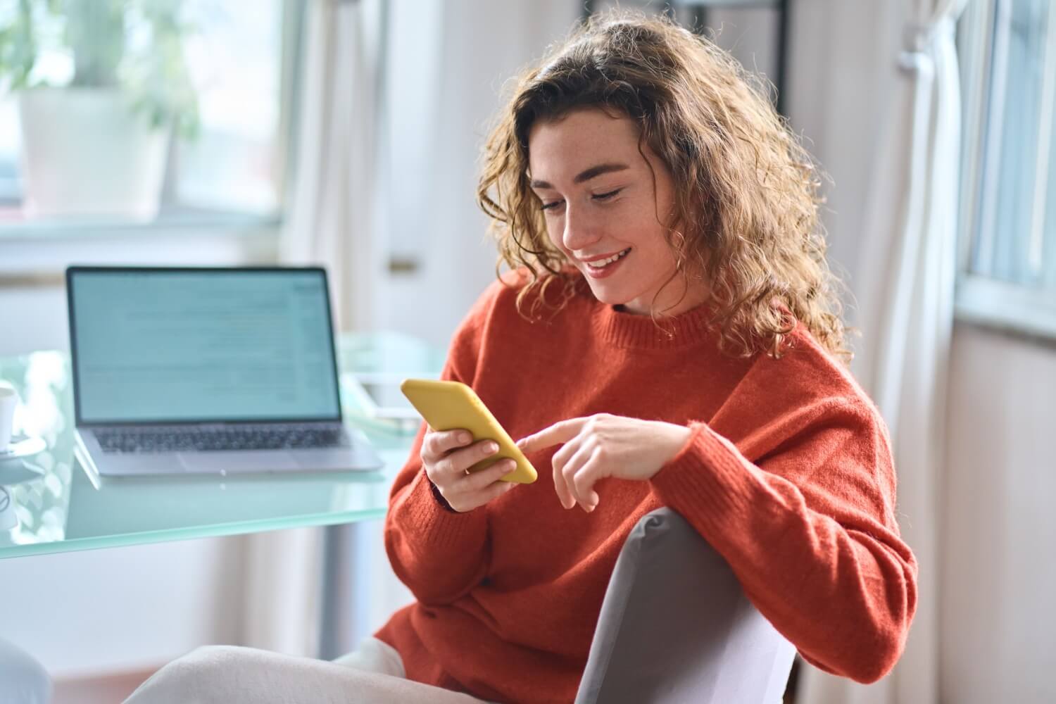 Smiling woman using phone
