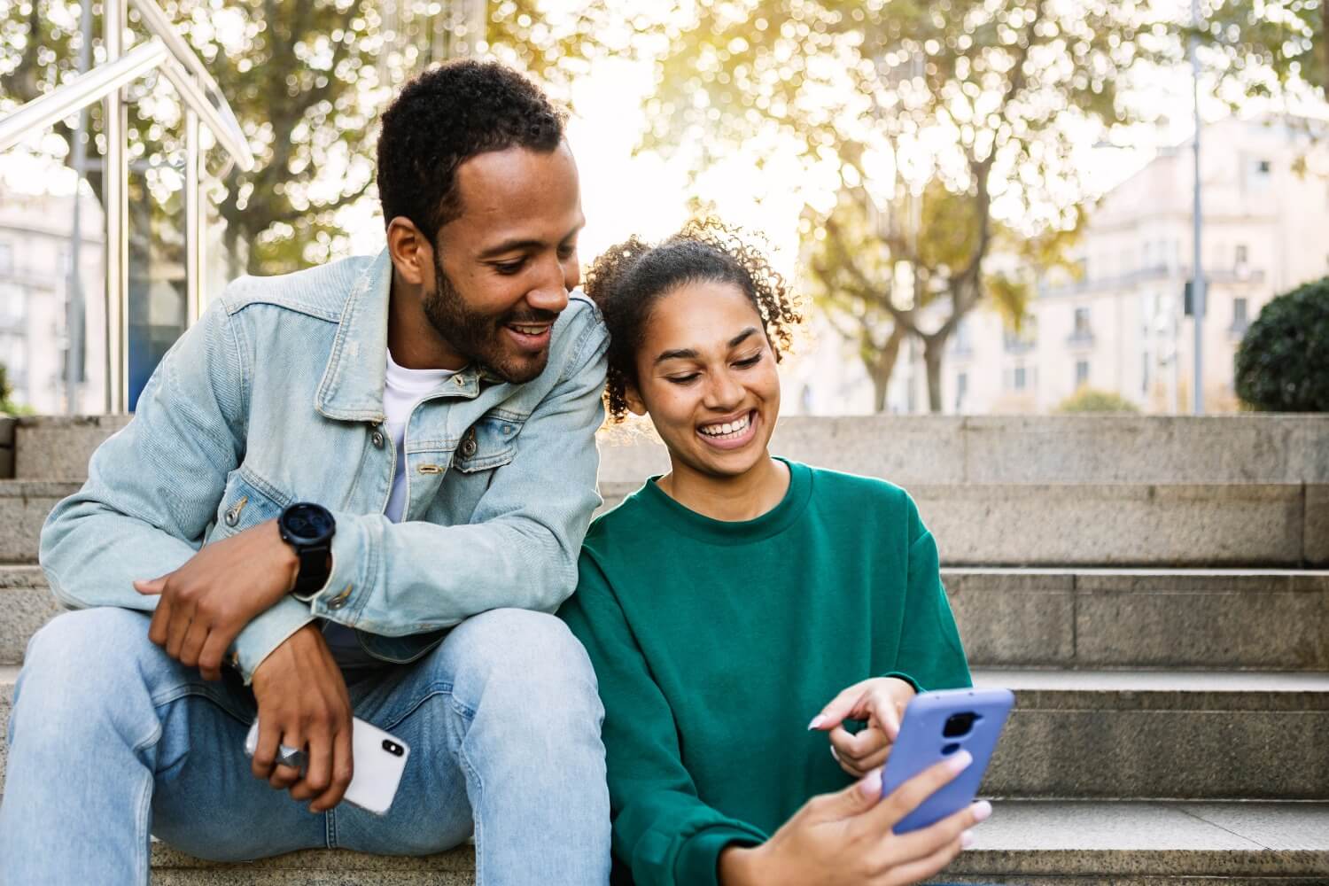 Smiling man and woman using phone